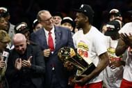 Kawhi Leonard celebrates with the Larry O'Brien Championship Trophy.
